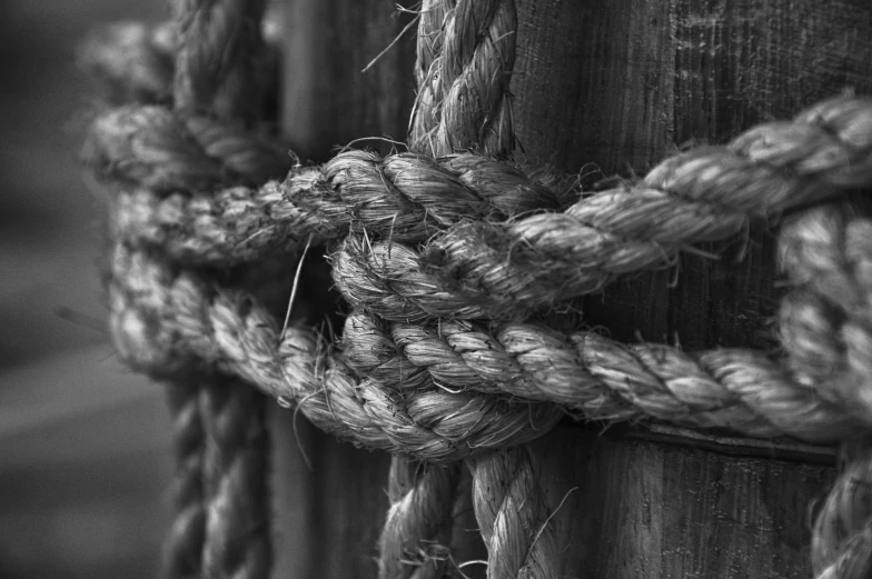 a close up of a rope wrapped around a wooden pole, by Alexander Robertson, bw photo, sergey krasovskiy, by joseph binder, low detailed