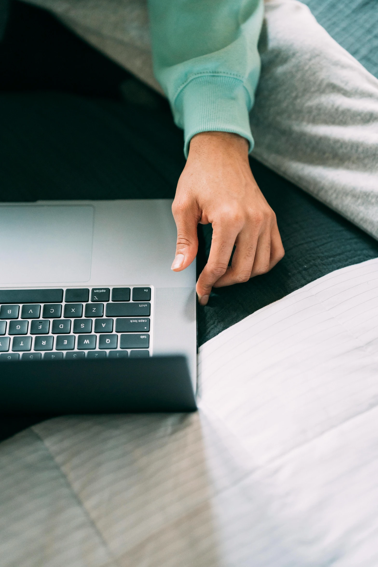 a person sitting on a bed using a laptop, zoomed in, thumbnail, premium, close - up photo