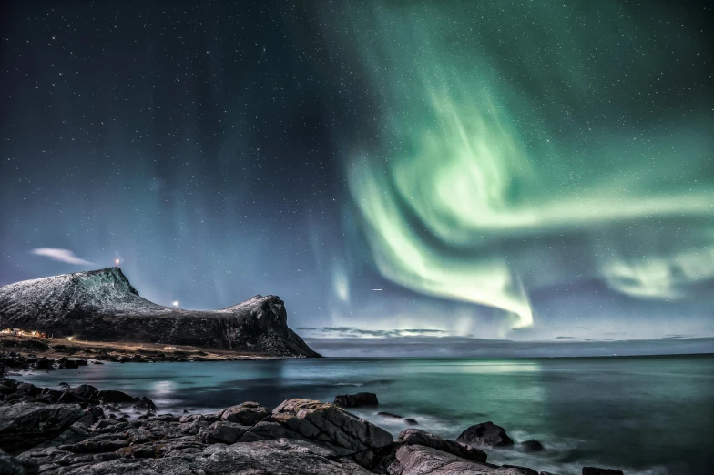 the aurora lights in the sky over a body of water, by Terese Nielsen, pexels contest winner, devils horns, grey, navy, travel