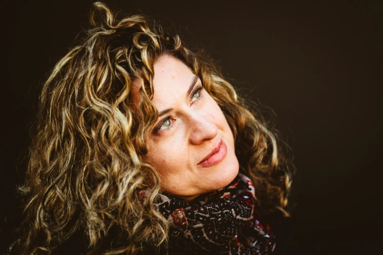 a woman with curly hair wearing a scarf, a portrait, by Meredith Dillman, unsplash, portrait image, 2000s photo, brown, mirka andolfo