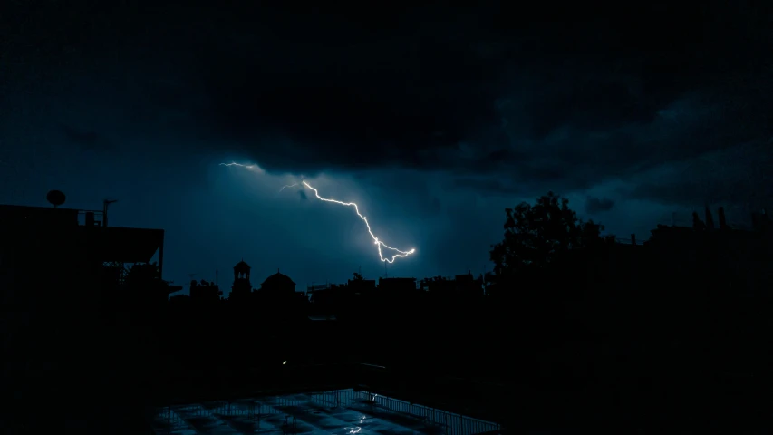 a lightning bolt hitting through a dark sky, pexels contest winner, hurufiyya, ☁🌪🌙👩🏾, thunderstorm in marrakech, dramatic white and blue lighting, multiple stories