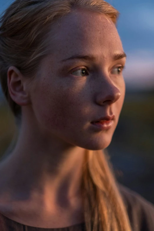 a woman with long blonde hair standing in a field, unsplash, hyperrealism, evening lighting, soft freckles, sydney sweeney, close-up portrait film still