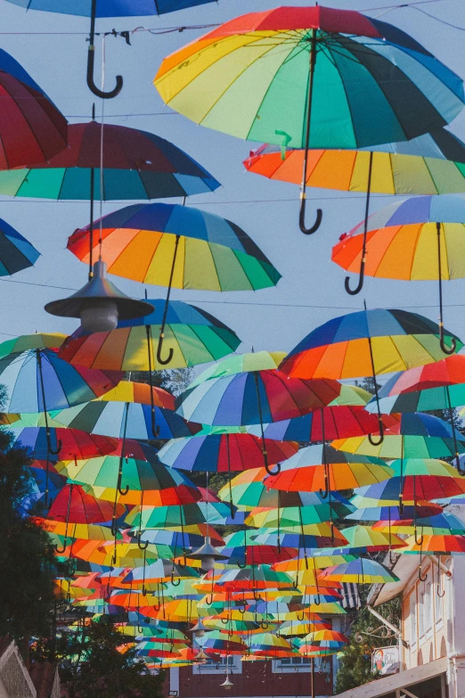 a street filled with lots of colorful umbrellas, unsplash contest winner, conceptual art, bay area, sunlit, colorful”