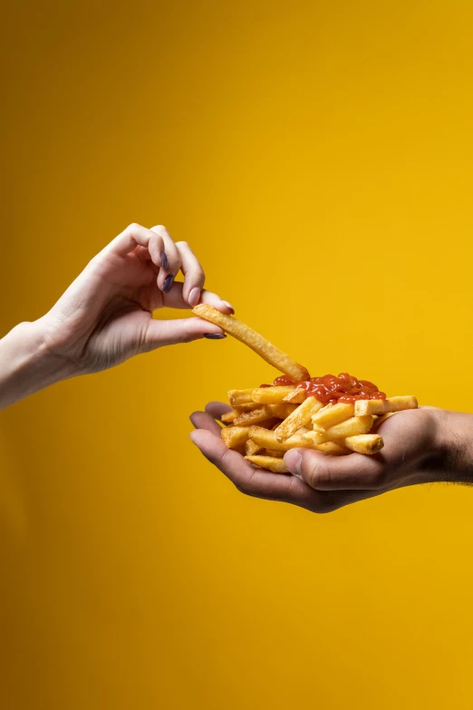 a close up of a person holding a plate of food, fries, clemens ascher, reaching out to each other, mustard and ketchup