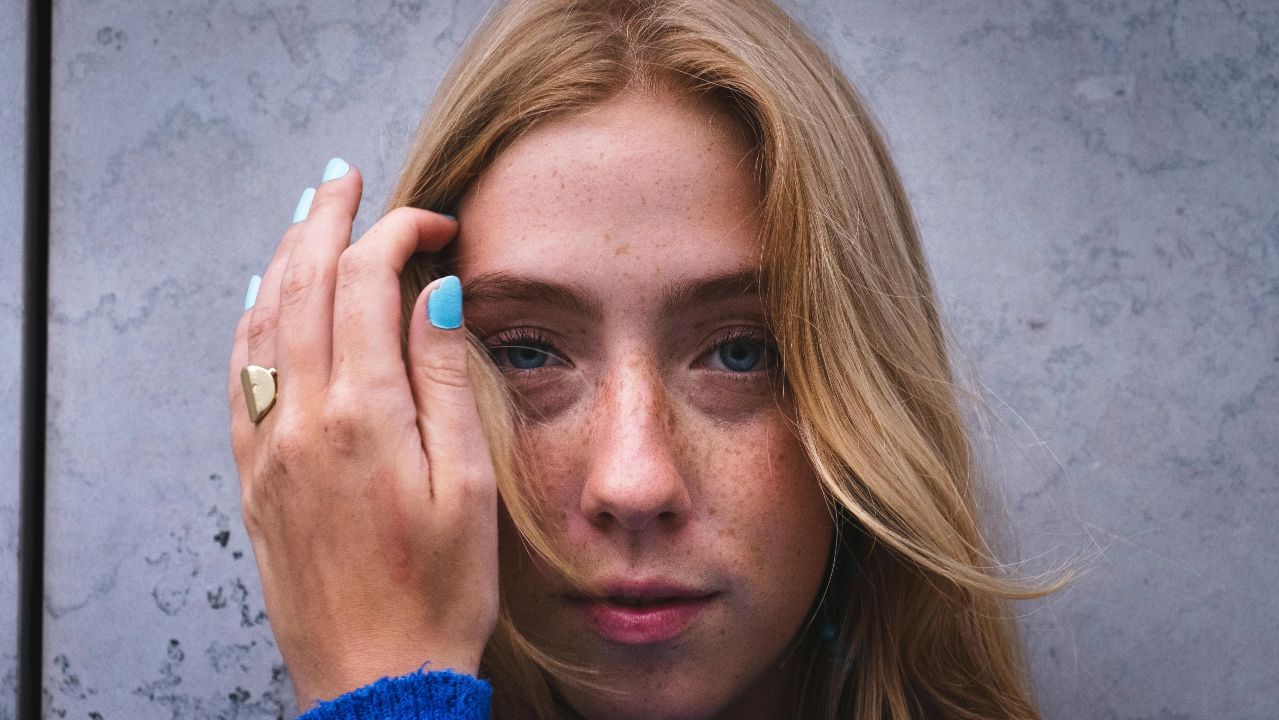 a close up of a person holding a cell phone, a photo, inspired by Elsa Bleda, trending on pexels, hyperrealism, blonde hair blue eyes, freckle, portrait of depressed teen, model posing