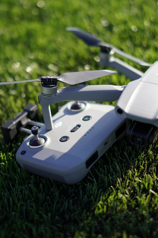 a white drone sitting on top of a lush green field, photo of a model, uploaded, hyperdetailed!, electronics