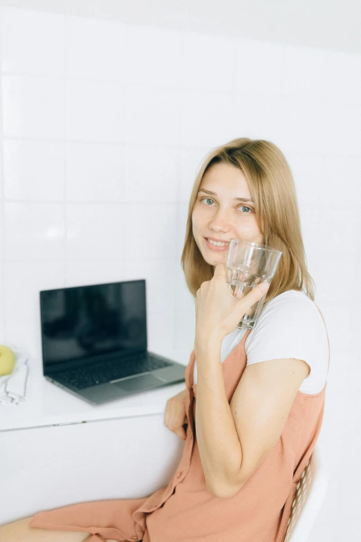 a woman sitting in a chair talking on a cell phone, peacefully drinking river water, in front of a computer, sofya emelenko, headshot profile picture