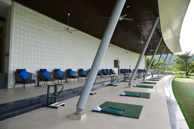 a row of golf mats lined up on the side of a building, hoang lap, mezzanine, intermediate art, local gym