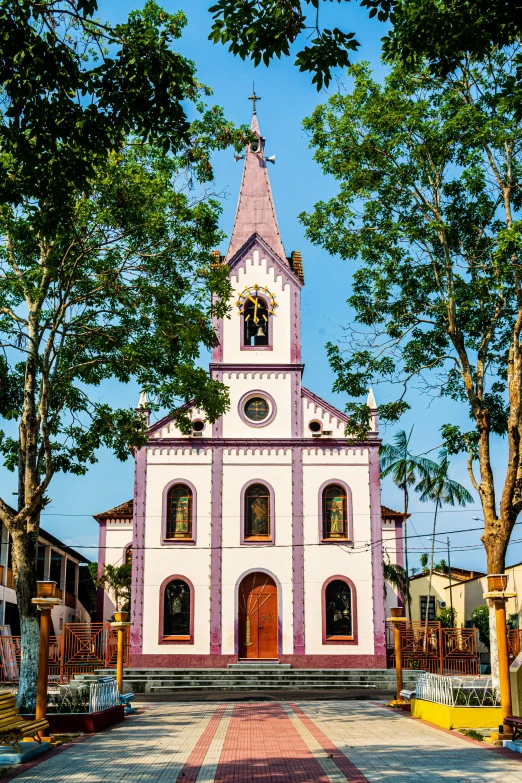 a pink and white church with a clock tower, inspired by Francis Souza, renaissance, purple roofs, brazil, vibrant setting, square