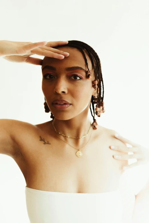 a woman in a white dress posing for a picture, an album cover, trending on pexels, renaissance, beads cross onbare chest, doja cat, non binary model, she has olive brown skin