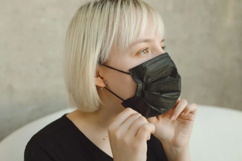 a woman with blonde hair wearing a black mask, by Emma Andijewska, pexels, made of lab tissue, cute woman, thumbnail, comfortable