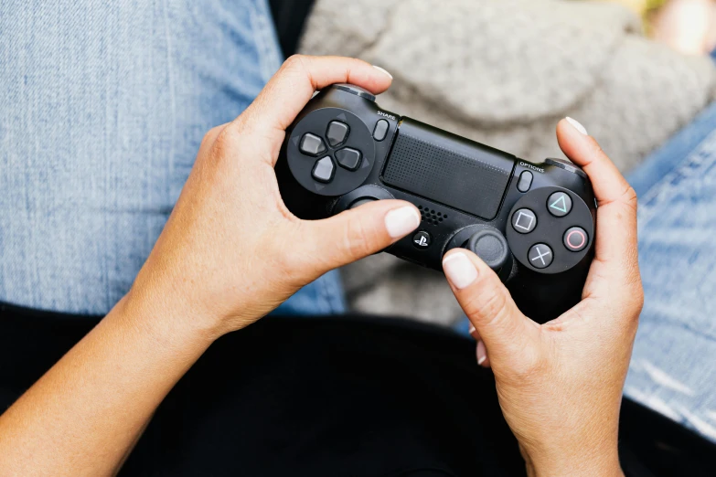 a person holding a video game controller in their hands, ps 4 gameplay, instagram photo, ad image, getty images