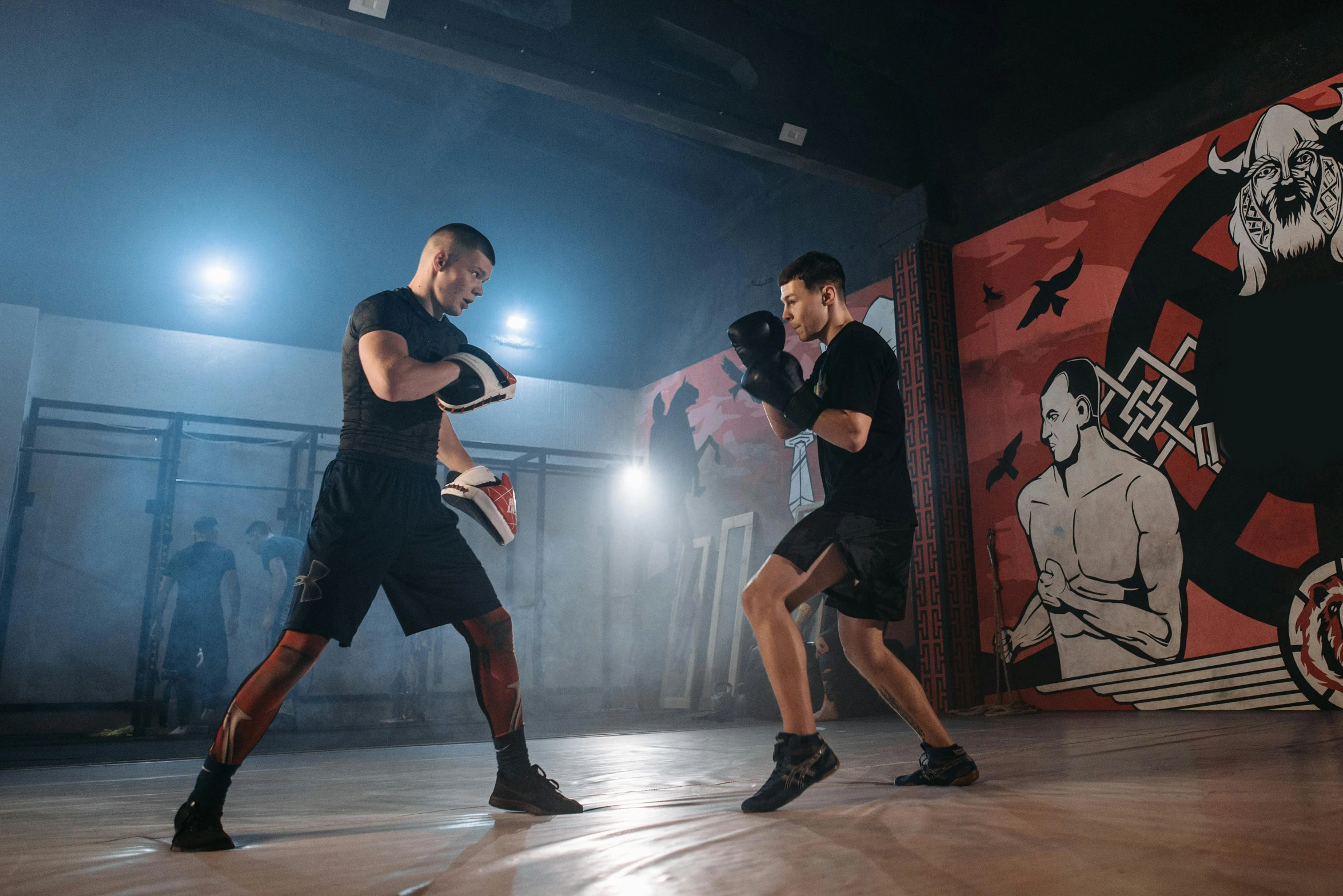 a couple of men standing on top of a wooden floor, boxing stance, wlop and andrei riabovitchev, central hub, profile image