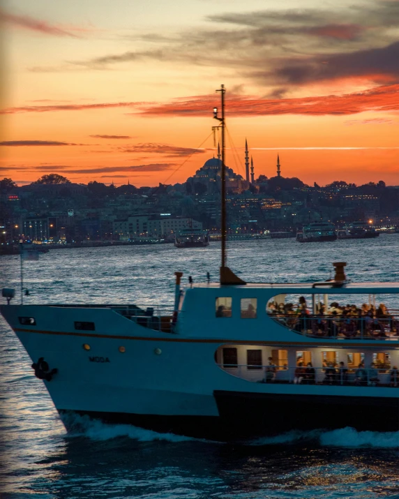 a large boat traveling across a body of water, by Niyazi Selimoglu, city sunset, slide show, nightlife, postprocessed