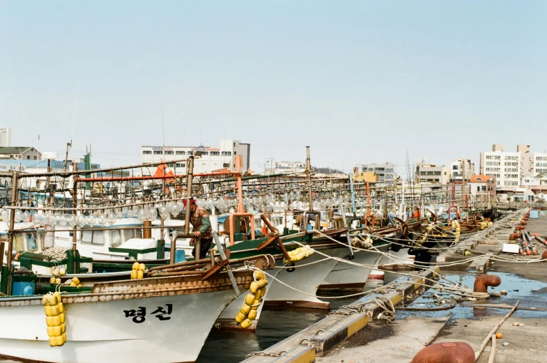 a number of boats in a body of water, a colorized photo, unsplash, shin hanga, fish seafood markets, demna gvasalia, 2000s photo