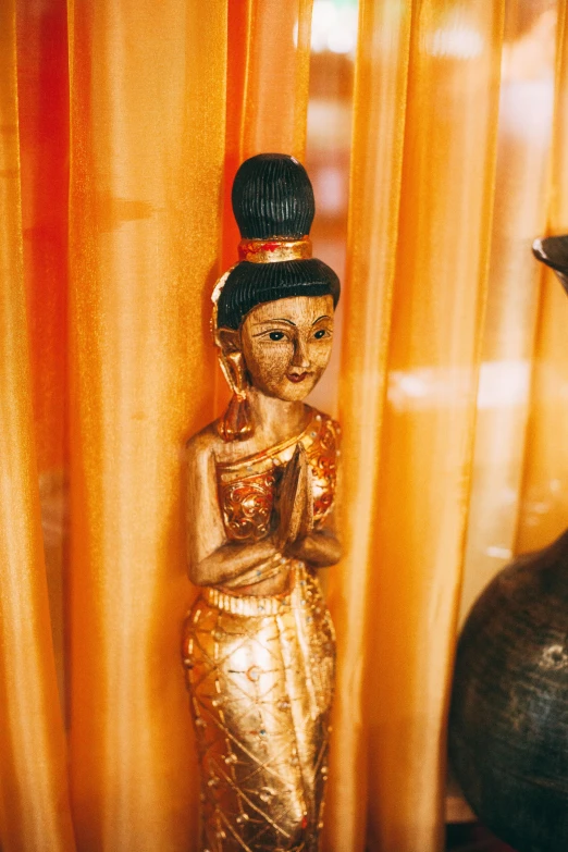 a statue of a woman standing next to a vase, gold inlay, health spa and meditation center, figurines, laos