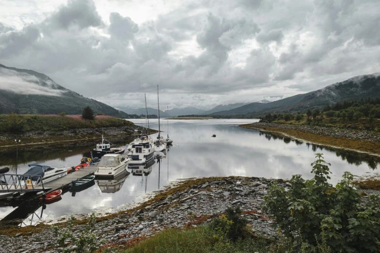 a group of boats sitting on top of a body of water, by Andrew Allan, pexels contest winner, hurufiyya, highlands, gordon onslow ford, thumbnail, moored