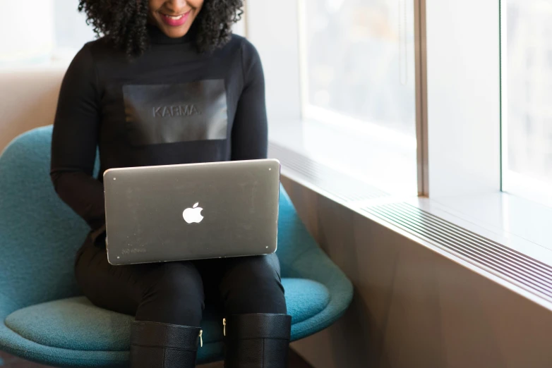 a woman sitting in a chair with a laptop, by Carey Morris, trending on unsplash, with apple, panel of black, 15081959 21121991 01012000 4k, elaborate detail