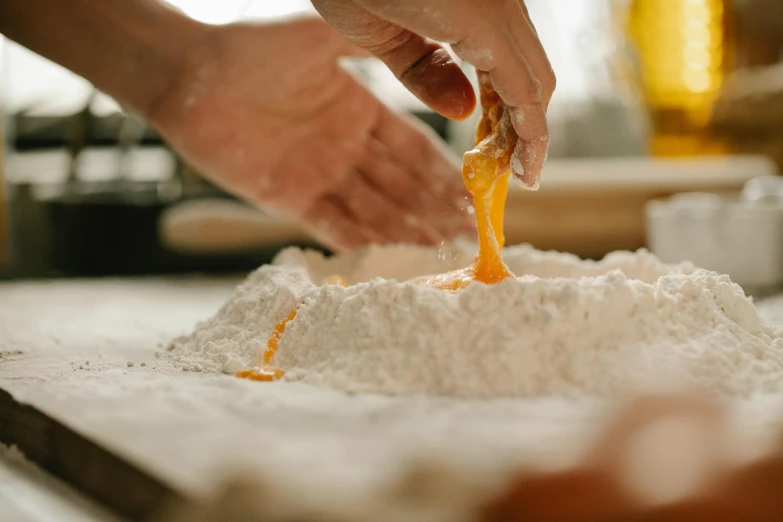 a close up of a person making food on a table, trending on pexels, covered in white flour, made of honey, manuka, ruffles