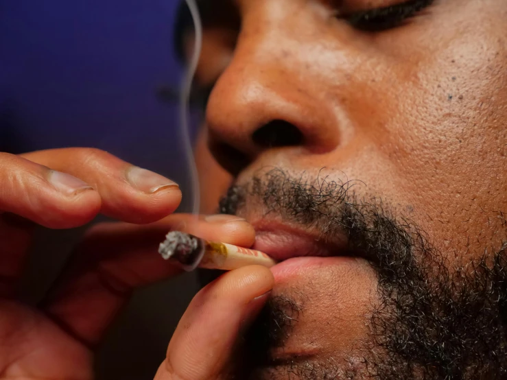 a close up of a person smoking a cigarette, ray lewis, ganja, thumbnail, photographed for reuters