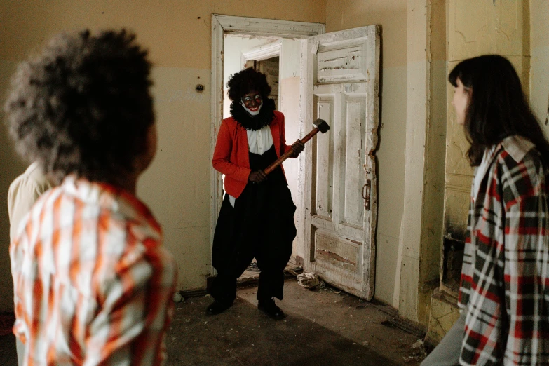 a group of people standing in front of a door, an album cover, by Jan Tengnagel, pexels contest winner, scary clown, with afro, attacking with axe, in a desolate abandoned house