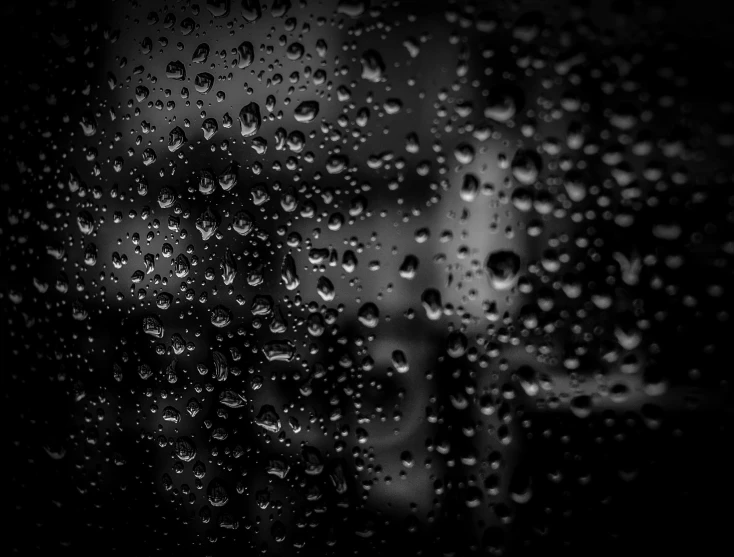 a black and white photo of water droplets on a window, a black and white photo, by Daniel Gelon, pexels, conceptual art, backround dark, monochrome hdr, beads of sweat, rainy night