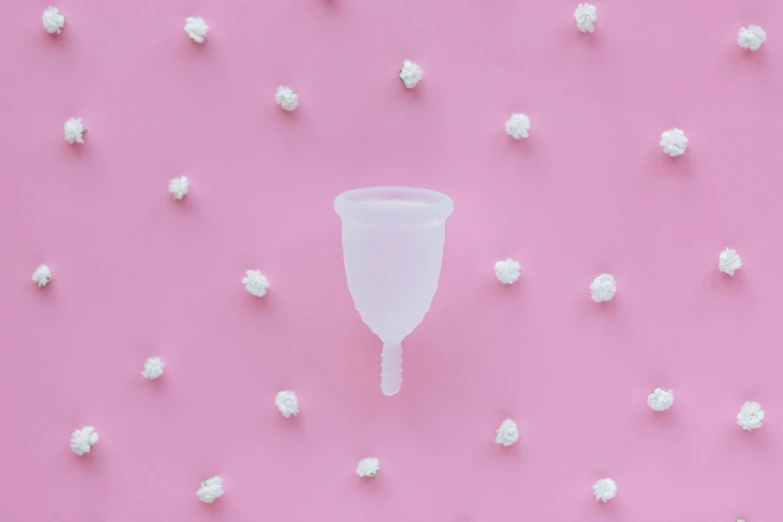 a plastic cup sitting on top of a pink surface, by Ryan Pancoast, trending on pexels, plasticien, nipple, cone shaped, white, 1 7 mm