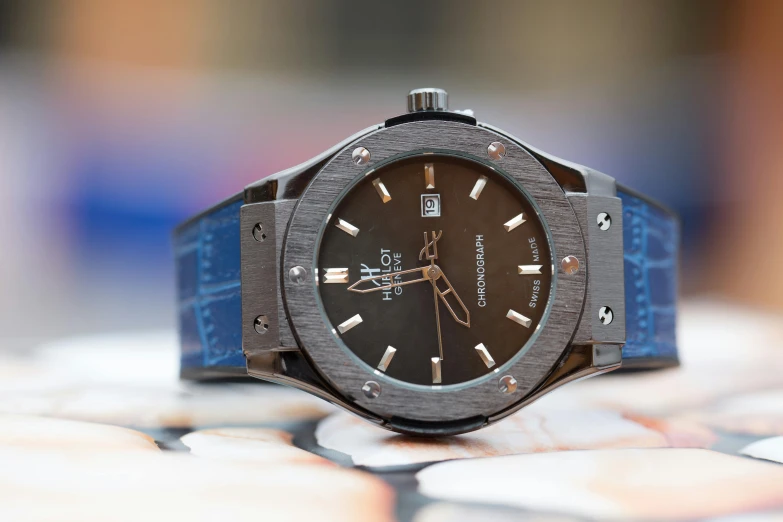 a close up of a watch on a table, hurufiyya, hublot, fan favorite, thumbnail, three quarter profile