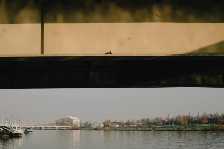 a large body of water next to a bridge, by Attila Meszlenyi, postminimalism, detailed medium format photo, street photo, 15081959 21121991 01012000 4k