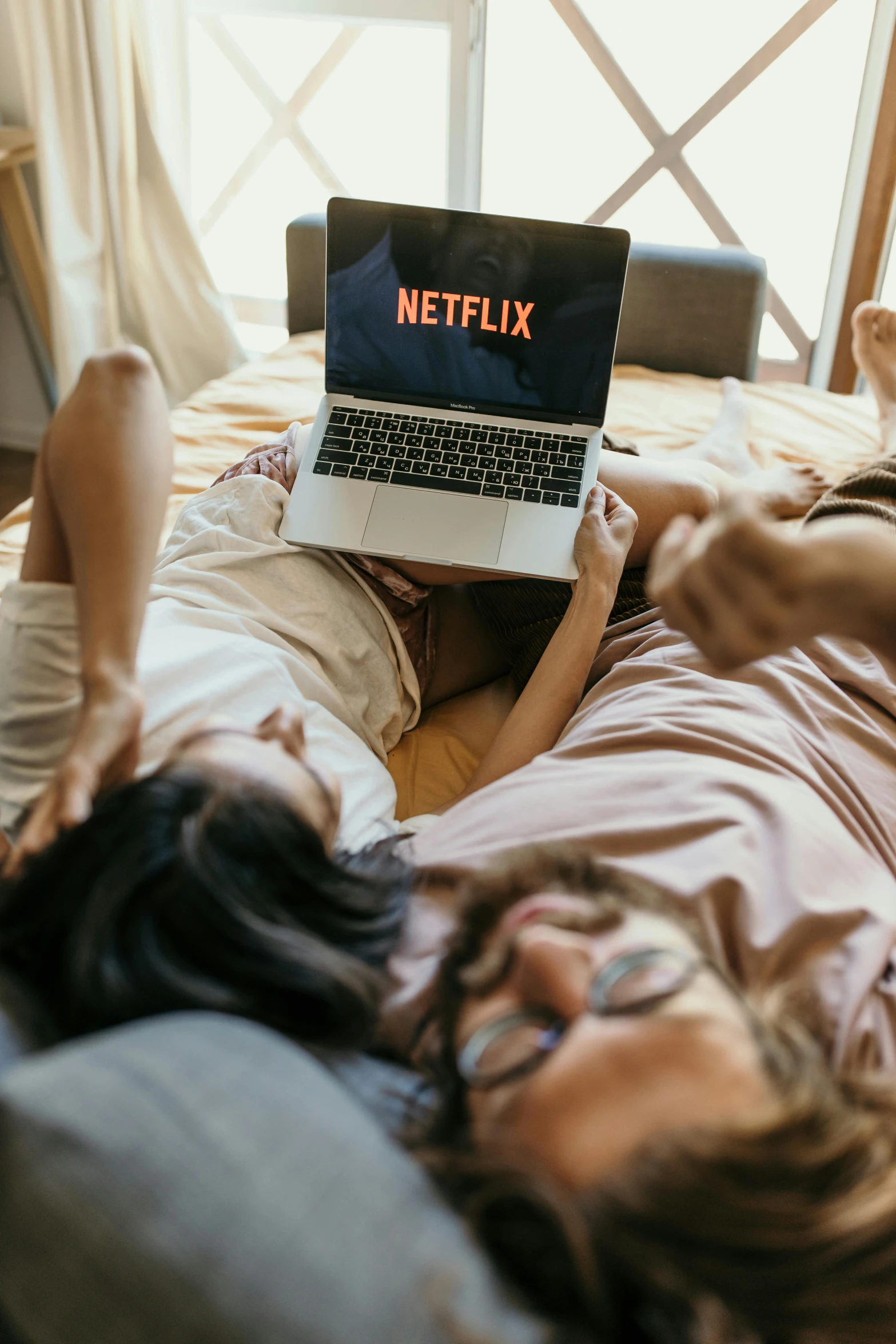 a man and a woman laying on a bed with a laptop, trending on pexels, renaissance, at netflix, best friends, netflix logo, movie still