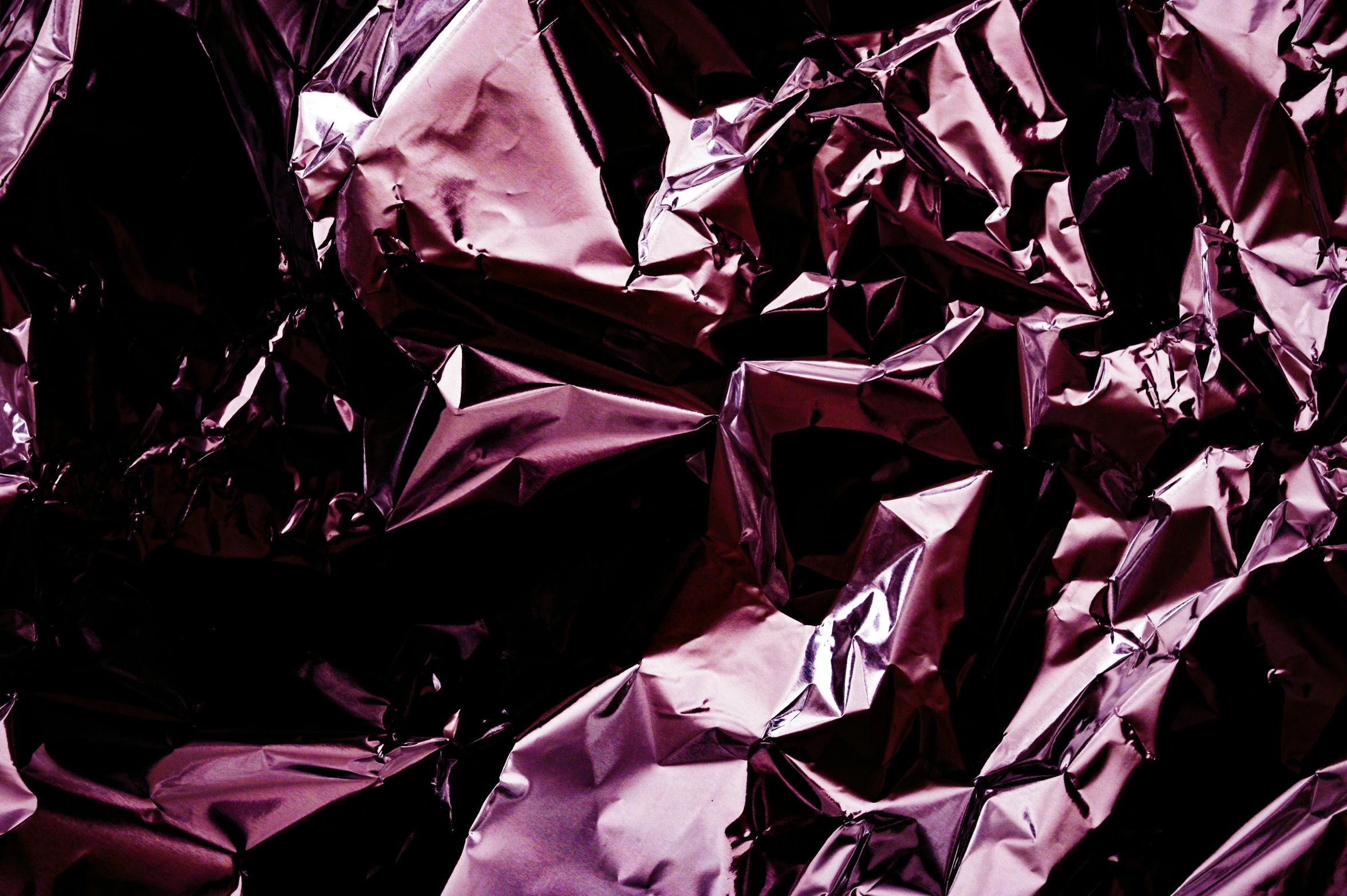 a pile of foil sitting on top of a table, an album cover, by Julia Pishtar, unsplash, plasticien, dark purple scheme, maroon red, ((purple)), wrinkled