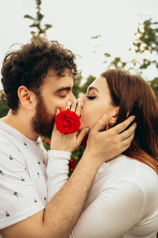 a man kissing a woman with a rose in his mouth, pexels contest winner, 👅 👅, square, hairy, bells