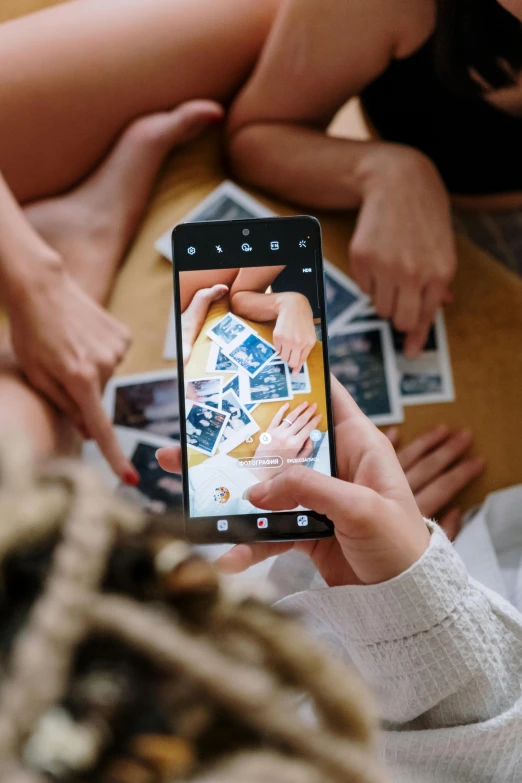 a woman taking a picture with her cell phone, a picture, trending on pexels, visual art, flatlay, inspect in inventory image, family photo, coloured polaroid photograph