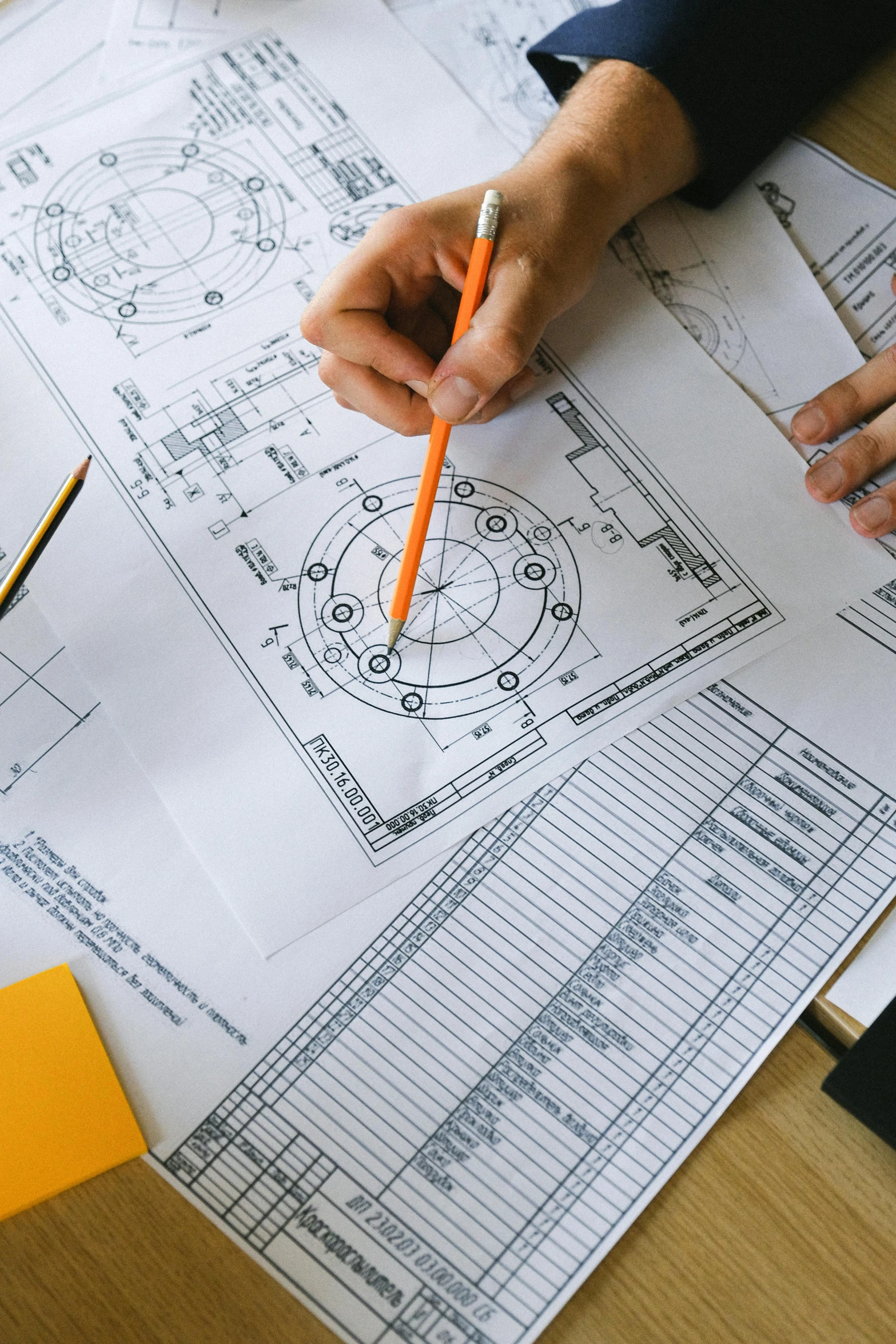 two people sitting at a table with blueprints and pencils, a detailed drawing, trending on unsplash, circular, mechanical hydraulics, inspect in inventory image, promo image