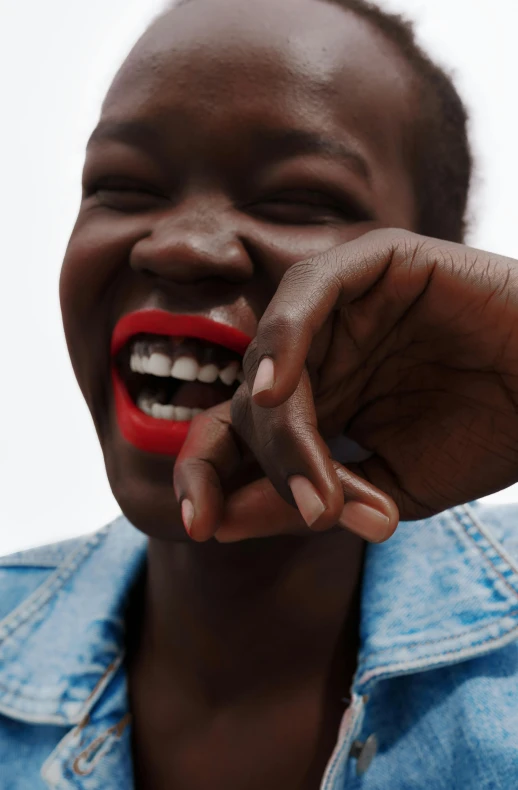 a close up of a person with a red lip, laughing, adut akech, slide show, laughingstock