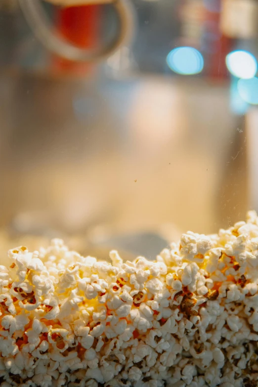 a bowl of popcorn sitting on top of a counter, trending on pexels, process art, cinematic frame, from street level, close up of single sugar crystal, market