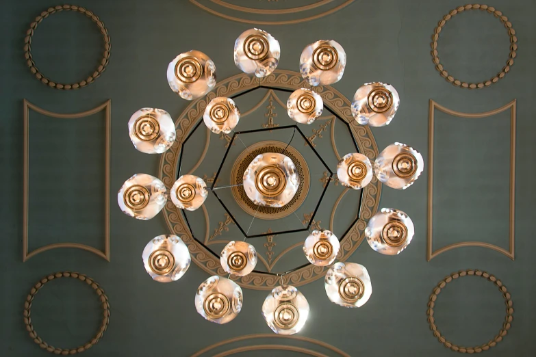 a chandelier hanging from the ceiling of a building, inspired by Anna Füssli, pexels, rococo, circle forms, looking up at camera, jury, verdigris