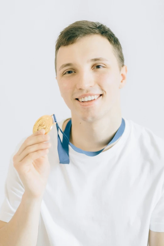 a young man holding a donut in one hand and a medal in the other, inspired by Ryan Pancoast, pexels contest winner, halfbody headshot, wearing a track suit, young man with short, oleg korolev