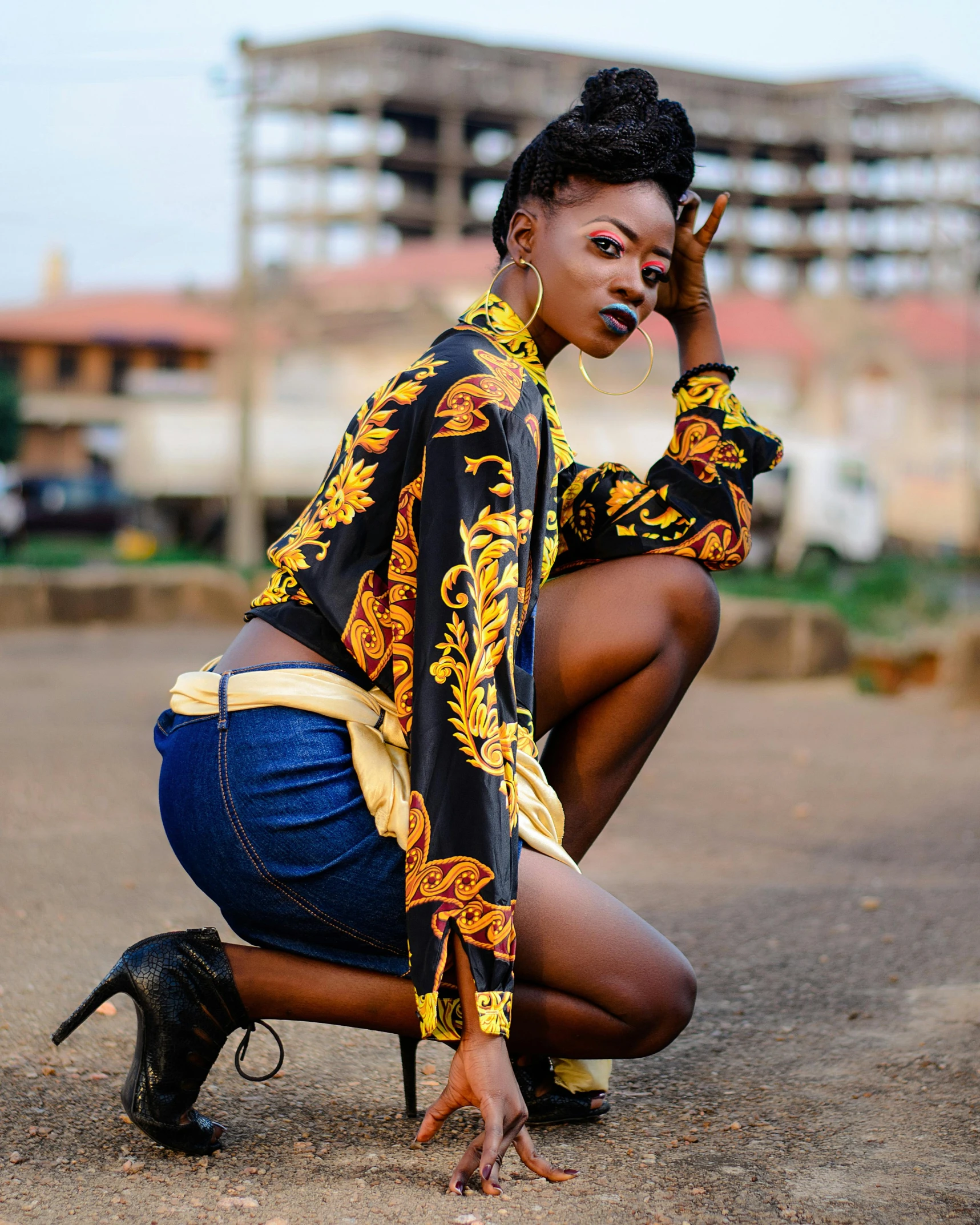 a woman kneeling on the ground posing for a picture, by Ingrida Kadaka, trending on pexels, afrofuturism, beautiful androgynous prince, black and yellow colors, thumbnail, 15081959 21121991 01012000 4k