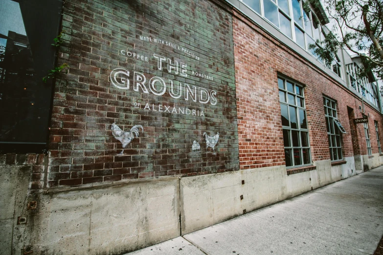 a sign that is on the side of a building, indieground, gravels around, surrounding the city, profile image