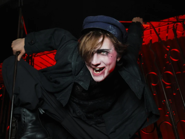 a man dressed as a vampire poses for a picture, pexels contest winner, bauhaus, teenage boy, animatronic, dark hat, the cheshire cat