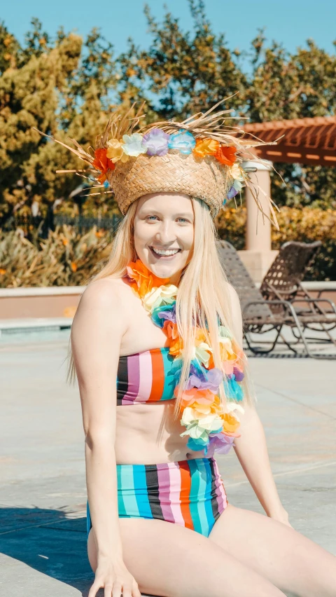 a woman sitting on top of a pool next to a giraffe, vivid flower crown, rainbow tubing, with straw hat, wearing seashell attire