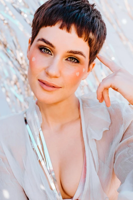 a woman in a white shirt posing for a picture, an album cover, inspired by Rhea Carmi, trending on pexels, pixie cut, transparent vibrant glowing skin, persian queen, soft lighting from above