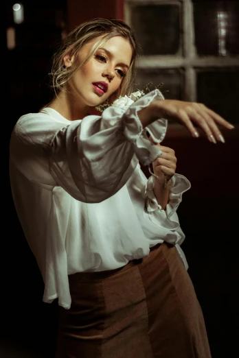 a woman in a white shirt and brown skirt, inspired by Elsa Bleda, renaissance, cinematic lighting photography, hands in her hair, elize theron, gloves and jewelry. motion