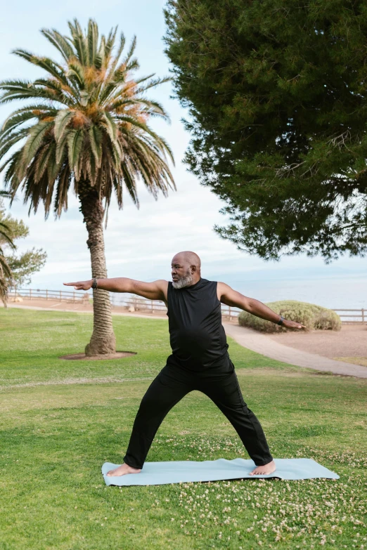 a man standing on a yoga mat in a park, a statue, by Lisa Milroy, happening, on the coast, samuel jackson, fully body pose, local gym