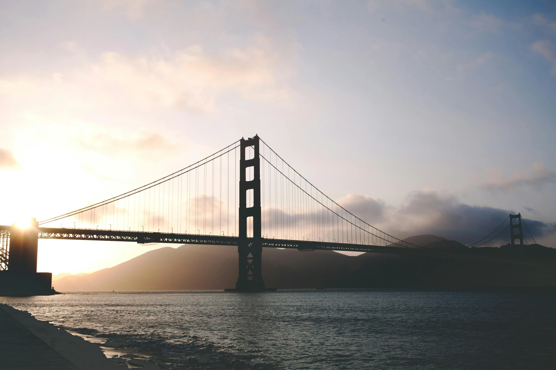 a view of the golden gate bridge at sunset, pexels contest winner, modernism, bridge over the water, desaturated, a single, a cozy