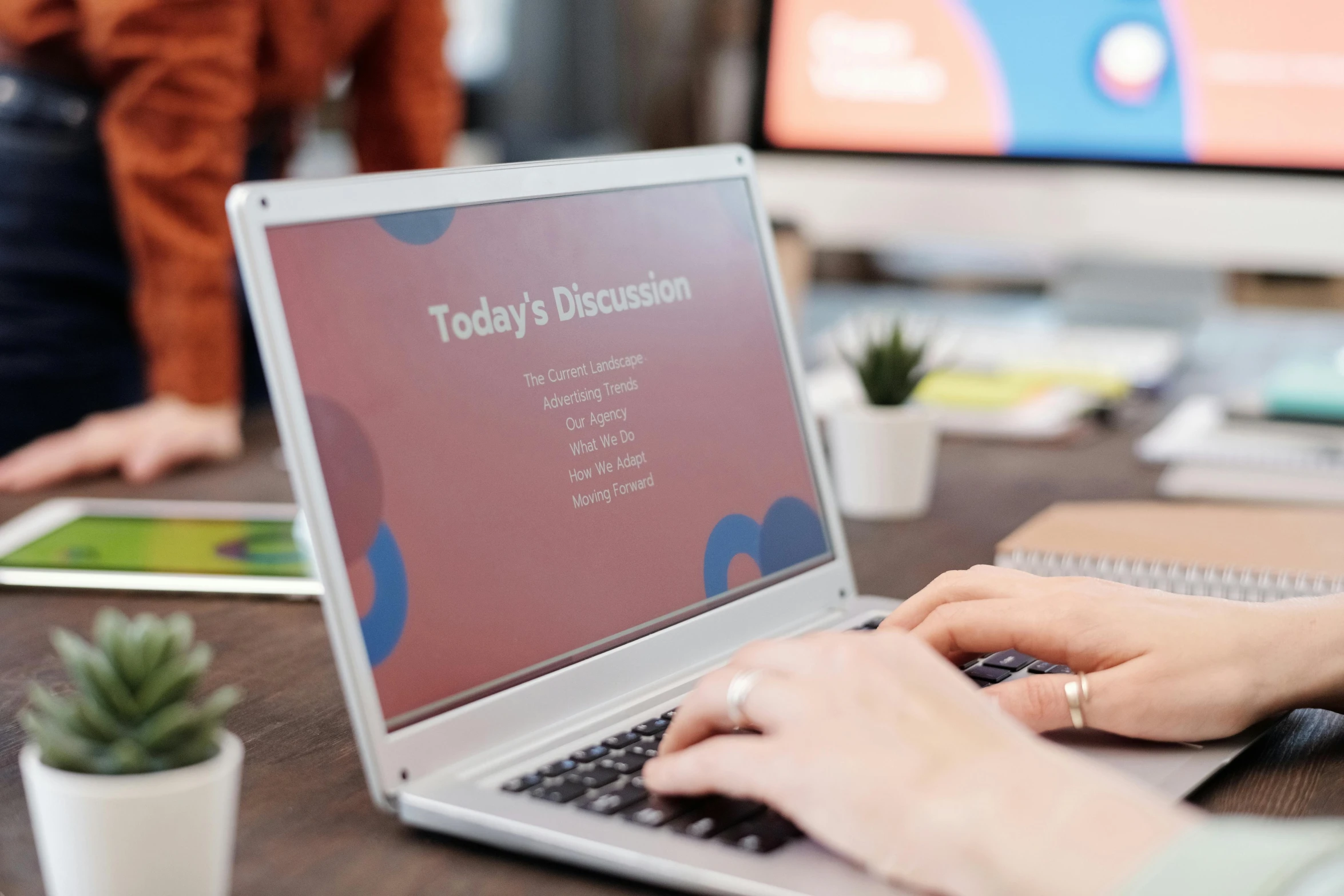 a close up of a person typing on a laptop, by Julia Pishtar, trending on unsplash, art & language, in a meeting room, wide screen format, advert, multi - coloured