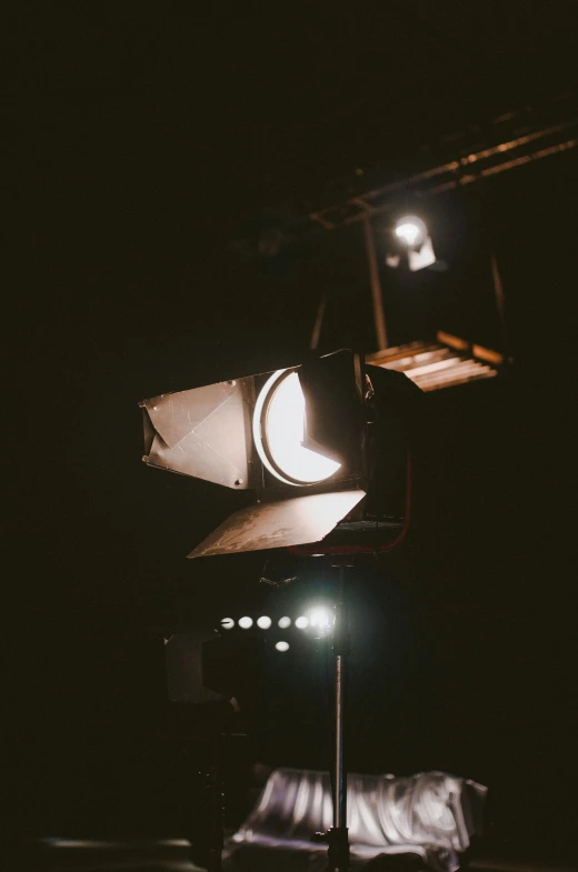 a traffic light sitting on top of a metal pole, an album cover, trending on unsplash, light and space, footage of a theater stage, floodlight, looking into camera, vsco film grain