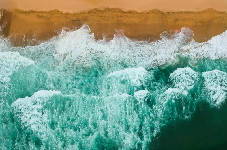 a large body of water next to a sandy beach, pexels contest winner, cresting waves and seafoam, ocean simulation, orange and teal color, slide show