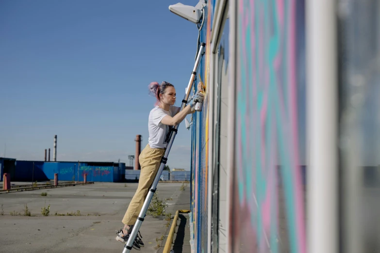 a little girl that is standing on a ladder, pexels contest winner, graffiti, avatar image, people at work, blue sky, nina tryggvadottir